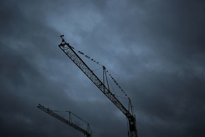 Low angle view of cranes at construction site