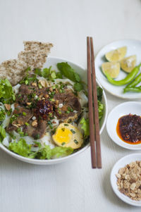 Vietnamese noodle - my quang, vietnamese traditional cuisine, noodles in bowl on the table 