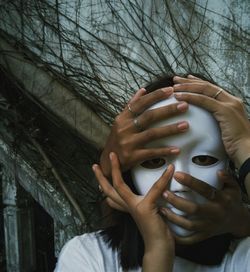 Hands touching woman wearing mask