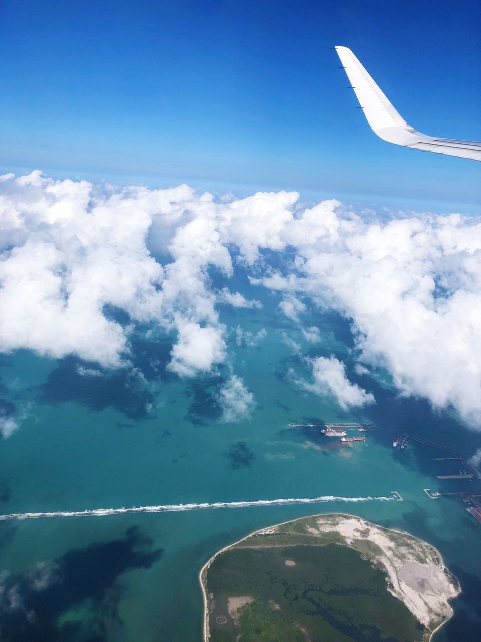 AERIAL VIEW OF CLOUDS OVER BLUE SKY