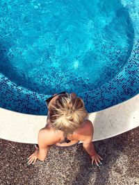 High angle view of woman relaxing in swimming pool