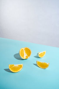 Fruits on table against white and blue background