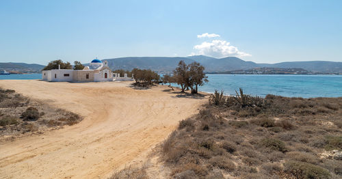 Scenic view of beach by sea against sky