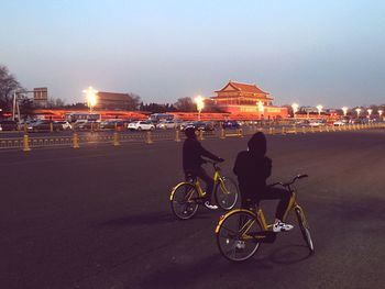 Man with bicycle in city at night