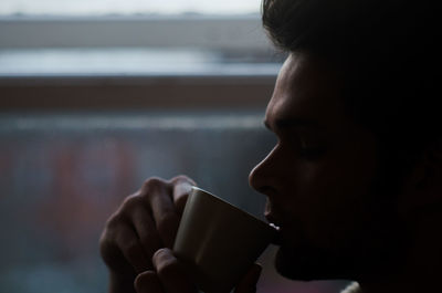 Close-up of man drinking coffee