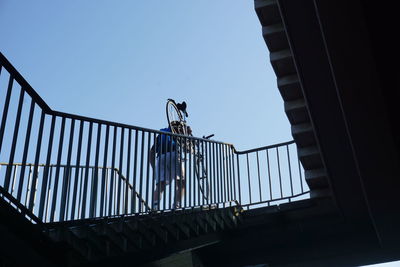 Low angle view of railing against clear sky