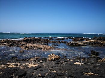 Scenic view of sea against clear blue sky