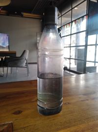 Close-up of empty glass bottle on table