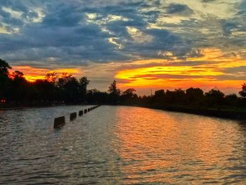 Scenic view of lake against orange sky