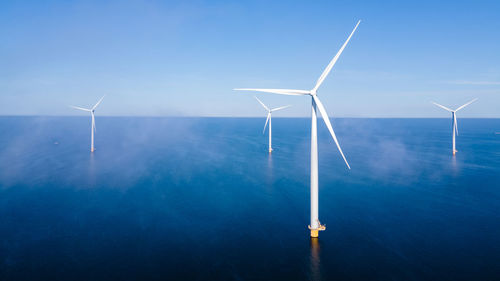 Low angle view of windmill against clear sky