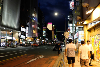 People walking on street at night