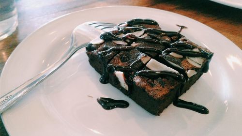 High angle view of chocolate cake in plate on table