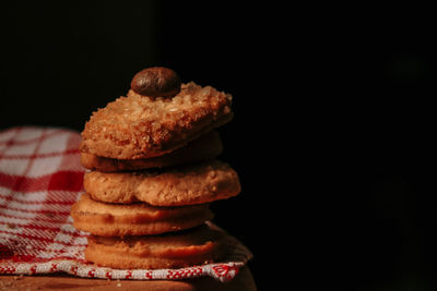 Stack of cookies against black background