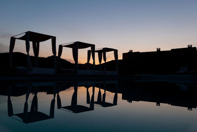 Silhouette built structure against clear sky during sunset