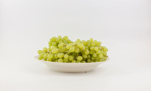 Close-up of fruits in bowl against white background