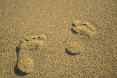 High angle view of footprints on sand at beach