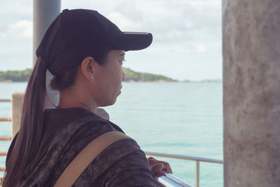 Portrait of young woman looking at sea