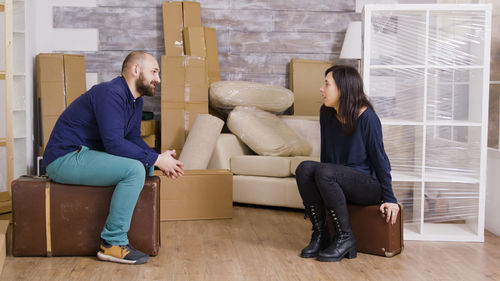 Young woman sitting on sofa at home