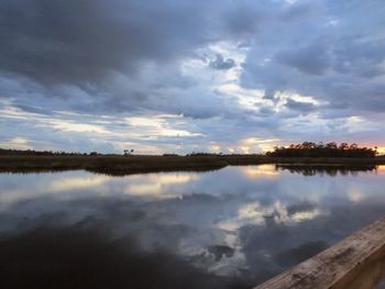 Scenic view of calm lake against cloudy sky