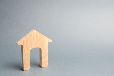 Miniature wooden house on a gray background. real estate. long-term rental apartments.