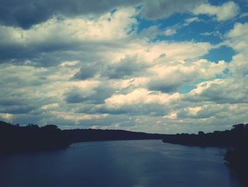 Scenic view of river and mountains against sky