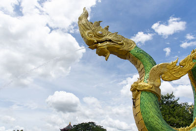 Low angle view of statue of angel against sky