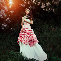 Portrait of beautiful woman standing in sunlight