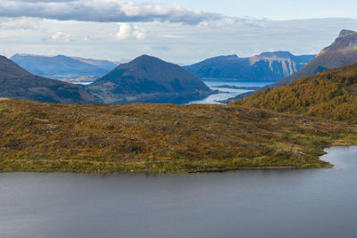 Scenic view of lake and mountains against sky