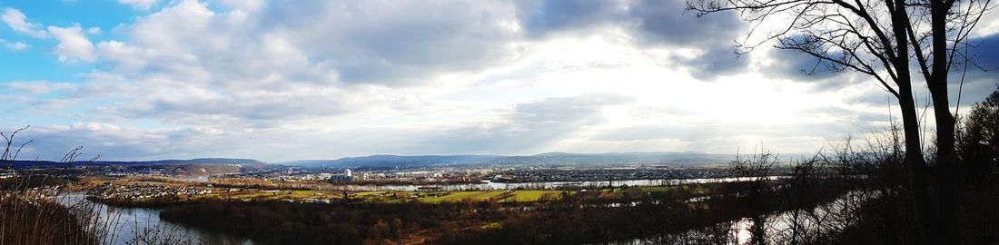 Panoramic view of river and trees against sky