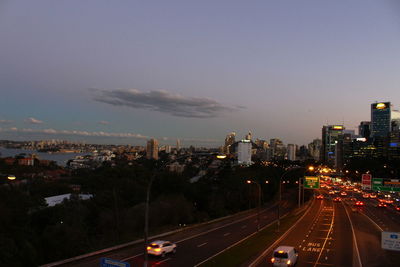 High angle view of illuminated street amidst buildings in city