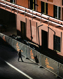 Full length of man standing by building in city