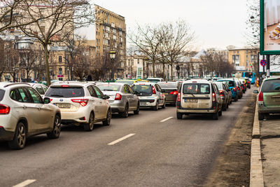 Cars on street by buildings in city