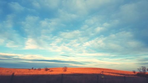 Scenic view of landscape against cloudy sky