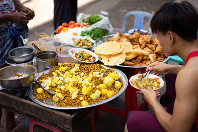 Midsection of man having food on table