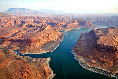 Aerial view of river flowing amidst canyon