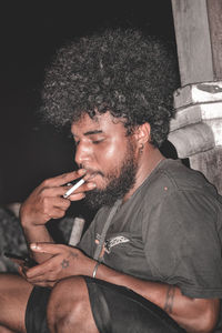 Young man smoking cigarette