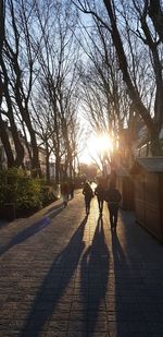 People walking on sidewalk in city