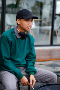 Portrait of young man sitting in car