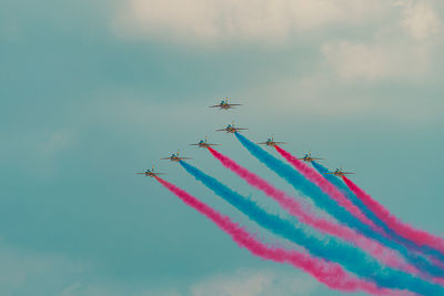 Low angle view of airplane flying against sky