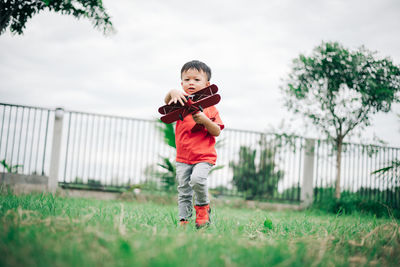 Full length portrait of boy on field