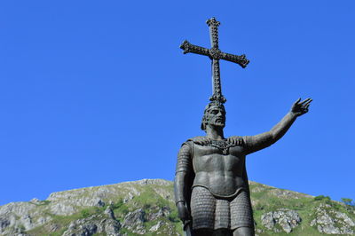 Low angle view of statue against clear blue sky