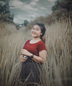 Young woman standing in field