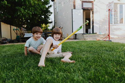 Portrait of happy friends sitting on field