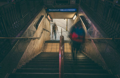 Rear view of man on stairs at subway station