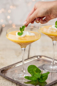 Close-up of hand pouring wine in glass on table