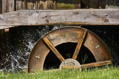 Old rusty wheel on field