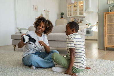 Family sitting on sofa at home