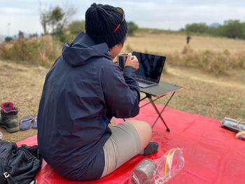 Rear view of man working on field