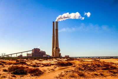 Smoke stacks against sky