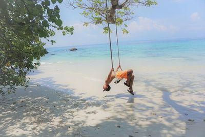 Person on beach against sky